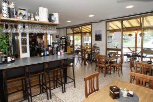 a bar in a restaurant with tables and chairs at Vesta in Gargnano