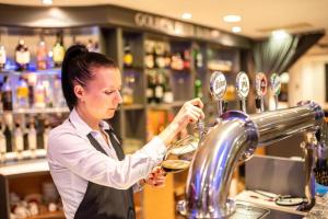 a woman preparing a drink at a bar at East City Budapest in Budapest