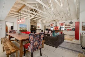 a living room with a table and a couch at Ocean Breeze by The Oyster Collection in Kenton on Sea
