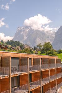 a building with a mountain in the background at Eiger Lodge Chic in Grindelwald