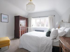 a bedroom with a white bed and a window at 5 Bed in Devizes oc-s34742 in Devizes