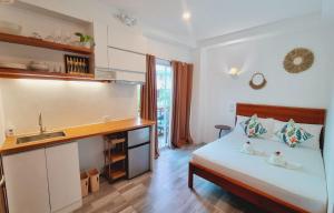 a bedroom with a bed and a sink and a kitchen at CiNta Hotel in Boracay