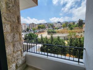 a balcony with a view of a city at HighLand Hotel in Aley