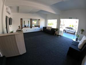 a living room with a couch and a car at LakeHouse Hotel & Suites in Villa Carlos Paz