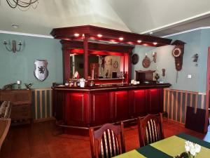 a bar in a restaurant with red lighting at POD ORŁEM in Wałcz
