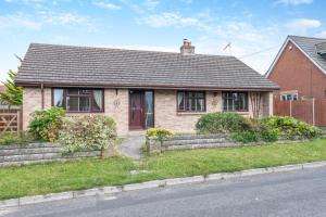 a small brick house with a fence at 2 Bed in Wool oc-r29949 in Wool