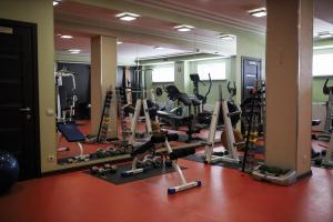 a gym with a lot of treadmills and machines at Grand-Marine Hotel & SPA in Odesa