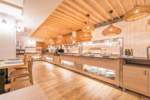 a large kitchen with a counter and a table at Hotel Viella in Vielha