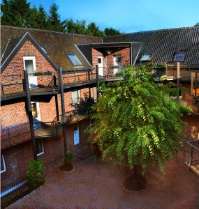 an overhead view of a building with a tree in the courtyard at Hotel Landhaus in Eschweiler