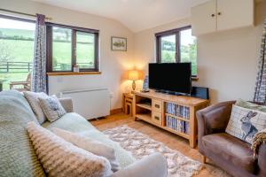 a living room with a couch and a tv at 2 Bed in Brecon oc-r33603 in Lower Chapel