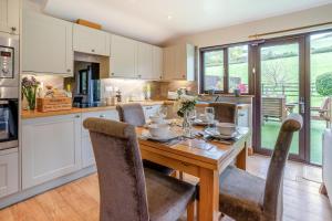 a kitchen with a wooden table with chairs around it at 2 Bed in Brecon oc-r33603 in Lower Chapel +13 photos