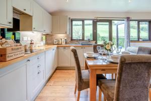 a kitchen with a wooden table and a dining room at 2 Bed in Brecon oc-r33603 in Lower Chapel