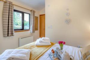 a room with a bed with towels and a window at 2 Bed in Brecon oc-r33603 in Lower Chapel