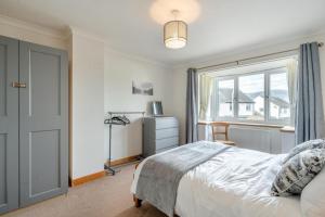 a bedroom with a bed and a large window at 3 Bed in Portinscale oc-w31059 in Portinscale
