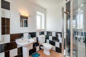 a bathroom with a toilet and a sink and a shower at 3 Bed in Portinscale oc-w31059 in Portinscale +18 photos