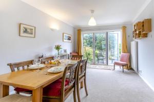 a kitchen and dining room with a wooden table and chairs at 2 Bed in Mumbles oc-d32021 in The Mumbles