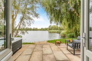 a patio with a view of a lake through a window at 1 Bed in Langtoft oc-l32683 in Langtoft