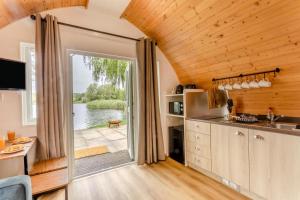 a kitchen with a large door leading to a lake at 1 Bed in Langtoft oc-l32683 in Langtoft