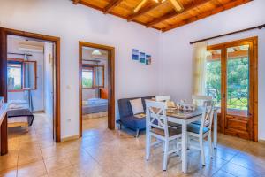 a dining room with a table and chairs at Christinas apartments in Ágios Matthaíos