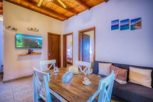 a living room with a wooden table and a couch at Christinas apartments in Ágios Matthaíos