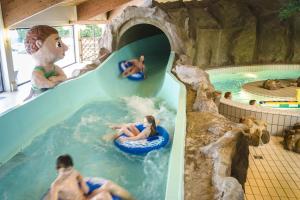 a group of people in a water slide at a water park at Landal Salztal Paradies in Bad Sachsa