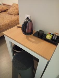 a table with a tea kettle on top of it at Hôtel de l'abbaye in Saint-Savin