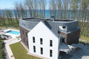an aerial view of a house with a swimming pool at CLIFF Trzęsacz - sea view apartments in Trzęsacz