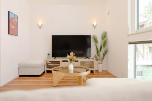 a living room with a tv and a coffee table at Hakuba Caesar in Hakuba