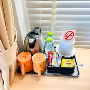 a tray with food and drinks and a coffee maker at Casa De Coral Boutique Hotel in Kata Beach