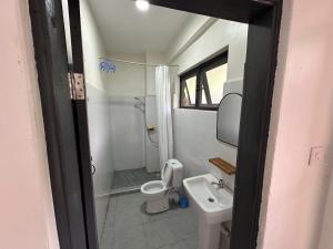 a small bathroom with a toilet and a sink at Kapto Camp in Kapchorwa