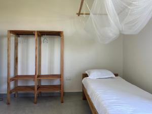 a room with a bed and a book shelf at Kapto Camp in Kapchorwa
