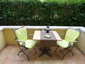 a table and two chairs on a patio at Guesthouse Casa Nova in Poreč