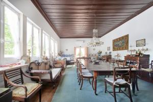 a dining room with a large wooden table and chairs at Quinta da Alcaidaria Mor in Ourém