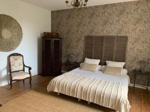 a bedroom with a large bed and a chair at Château Sainte BARBE in Loriol-du-Comtat +46 photos
