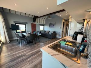 a kitchen and living room with a sink and a couch at Lifeboat House in Skerries +16 photos