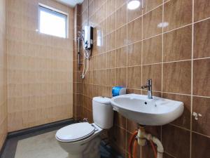 a bathroom with a toilet and a sink at Eden 8pax 3Rooms apartment near Kuching Airport in Kuching +13 photos
