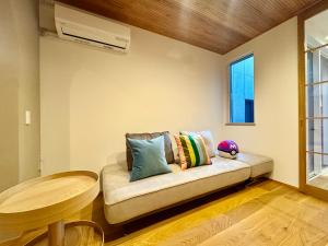 a couch in a room with a table and a window at Villa Monica Premium in Nagoya