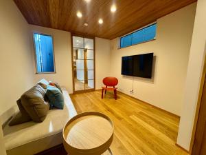 a living room with a couch and a table at Villa Monica Premium in Nagoya