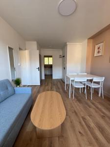 a living room with a couch and a table at La pause Tulliste in Tulle