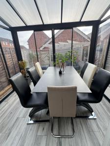 a dining room with a table and chairs at 4 bedroom, Sleeps 12, Free Parking in Corby and Weldon