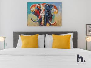 a bedroom with a bed with a painting of an elephant at Contractors - Free Parking - City Centre - Balcony - x21 in Hull