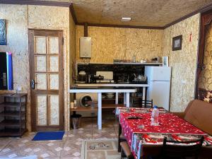 a kitchen with a table and a white refrigerator at Дом в Севан House in Sevan in Sevan