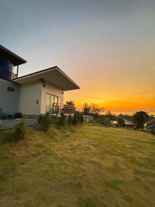 a house with the sunset in the background at Seaview phuwamin in Ko Lanta