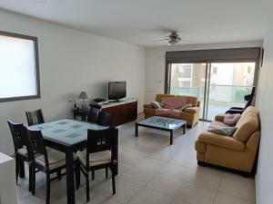 a living room with a table and a dining room at sitbonim in Netanya