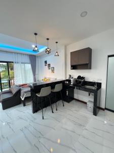 a kitchen and living room with a table and chairs at Seaview phuwamin in Ko Lanta +24 photos