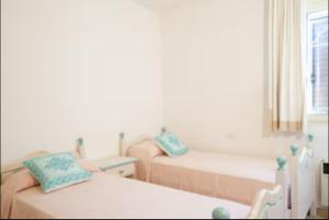 a living room with two beds and a window at Orsa sul mare a Baja Sardinia in Cala Bitta +64 photos