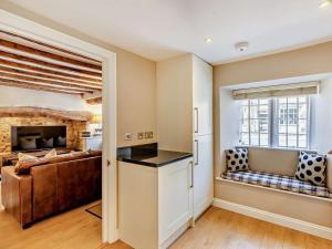 a living room with a couch and a fireplace at 2 Bed in Broadway oc-28985 in Broadway