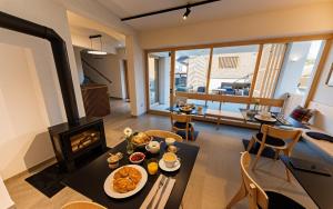 a living room with a table with food and a fireplace at Old Coach House in Bled
