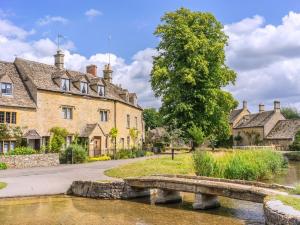 a stone bridge over a river in an old house at 2 Bed in Broadway oc-28985 in Broadway