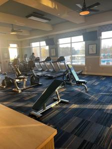 a gym with several tread machines in a room at Coastal Comfort in Jacksonville